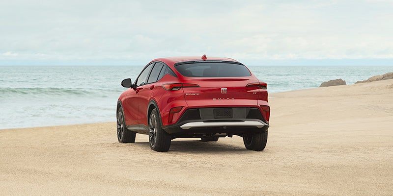 back view of red Buick Envista at sea side