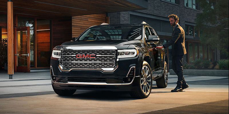 man opening door of GMC Acadia