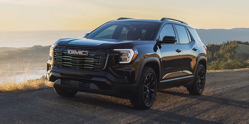 2026 GMC Terrain black SUV on a scenic road